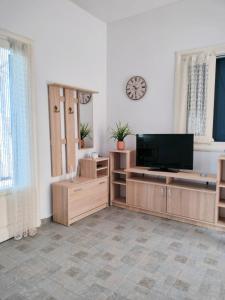a living room with a flat screen tv on a wall at Blue Calm House Kythnos in Agios Dimitrios