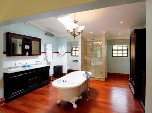 a large bathroom with a tub and a sink at New England Cottage by First Private Stays in Underberg +61 photos