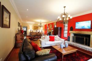 a living room with a couch and a fireplace at New England Cottage by First Private Stays in Underberg