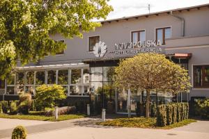 a building with a sign on the front of it at Novopolska - Hotel i Restauracja in Kościan