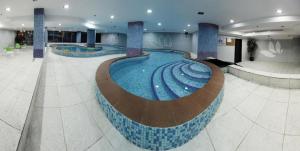a large swimming pool in a hotel lobby at Hayat Watheer for serviced Apartment in Dammam