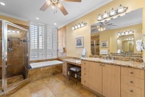 a bathroom with two sinks and a shower and a tub at La Playa 1001 in Perdido Key +59 photos