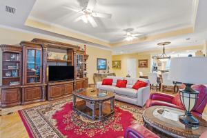 a living room with a couch and a tv at La Playa 1001 in Perdido Key