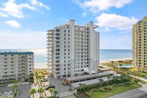an aerial view of a large white building next to the beach at La Playa 1001 in Perdido Key