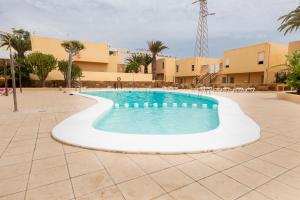 a swimming pool in the middle of a courtyard at Oasis in Costa Calma