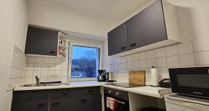 a kitchen with a sink and a window at Wohnung direkt an den Externsteinen in Horn-Bad Meinberg