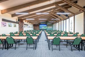 an empty room with tables and chairs in a classroom at Hannah Game Lodge in Ohrigstad