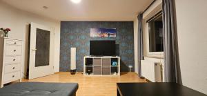 a living room with a flat screen tv on a wall at Wohnung direkt an den Externsteinen in Horn-Bad Meinberg