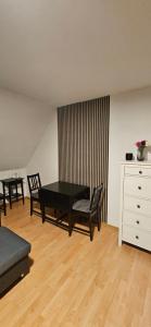 a living room with a black table and chairs at Wohnung direkt an den Externsteinen in Horn-Bad Meinberg +7 photos