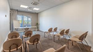 a classroom with chairs and a table and a whiteboard at Domaine De Saint Clair in Saint-Clair +29 photos