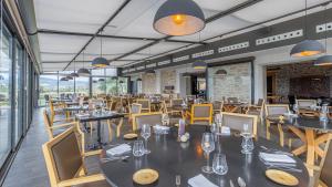 a restaurant with tables and chairs in a room at Domaine De Saint Clair in Saint-Clair