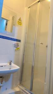 a bathroom with a shower and a sink at Fern Villa Hotel - Albert Road in Blackpool