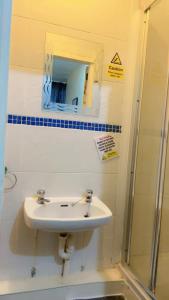 a bathroom with a sink and a mirror and a shower at Fern Villa Hotel - Albert Road in Blackpool +115 photos