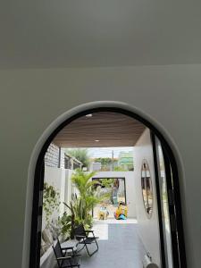 an archway in a building with chairs and a patio at NEMO house in Cu Lao Thu +24 photos