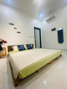 a bedroom with a large bed in a room at NEMO house in Cu Lao Thu