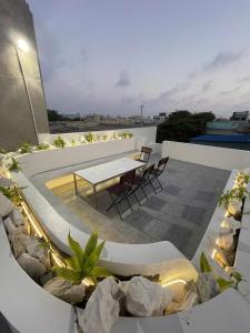 a patio with a table and chairs on a building at NEMO house in Cu Lao Thu