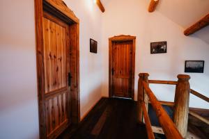 a staircase in a house with a wooden door at Cabana Huta Slavia in Şinteu