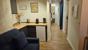 a kitchen with a counter and a long hallway at Arena Centro Rooms&Suites in Seville