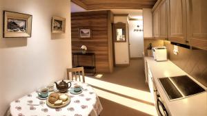 a small kitchen with a table and a kitchen gmaxwell gmaxwell gmaxwell gmaxwell at Chalet Les Alpes in Val-d'Isère +47 photos