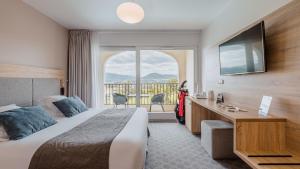 a hotel room with a bed and a large window at Domaine De Saint Clair in Saint-Clair