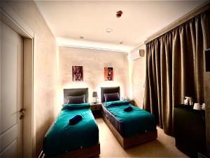 a bedroom with two beds and a window at Heritage Cairo Hotel Taalat Harb in Cairo