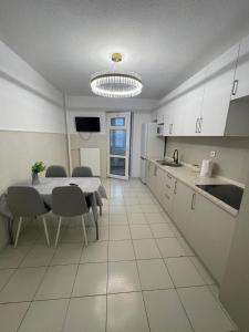 a kitchen and dining room with a table and chairs at RentHouse Samal in Astana