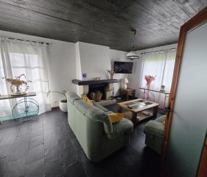 a living room with a couch and a table at Camiño da Vieira in Padrón