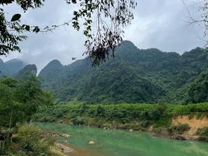 a river in a valley with mountains in the background at Danh Lam Homestay in Kon Rung (1)