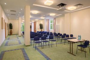 a large room with chairs and tables in it at IFA Graal-Müritz Hotel & Spa in Graal-Müritz +50 photos