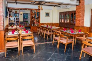 a dining room with wooden tables and chairs at Hotel Yechu Comfort Heritage in Bhaktapur
