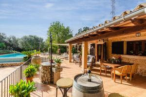 a patio with a table and chairs and a pool at YourHouse Padri de Inca in Inca