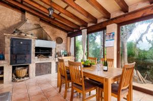 a dining room with a wooden table and chairs at YourHouse Padri de Inca in Inca