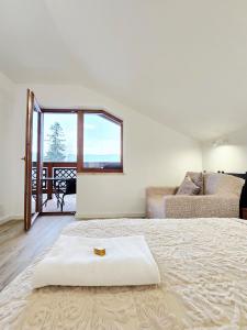 a bedroom with a large bed and a couch at Holiday Family Raj pod Sosnami centrum miasta! in Szklarska Poręba
