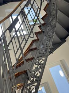 a metal spiral staircase in a house at DH Hotel Deutsches Haus Mittweida - Ihr digitales Hotel in Mittweida