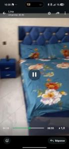 a picture of a bed with flowers on it at Jawhara zarka in Saïdia