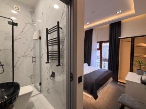 a bathroom with a shower and a bedroom at JM Central Boutique Hotel in Baku +49 photos