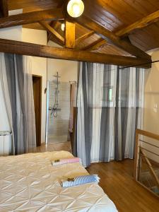 a bedroom with two beds in a room with wooden ceilings at gîte de Fontjalabert en campagne tout confort in Lisle-sur-Tarn +41 photos