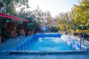 a large pool with a slide in a park at Hotel Yechu Comfort Heritage in Bhaktapur
