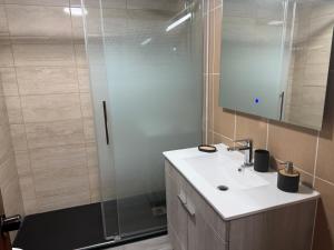 a bathroom with a sink and a shower at Seaview Suite in Caniço
