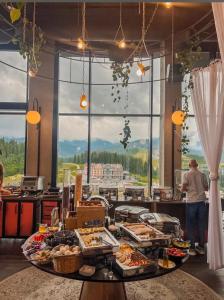 a buffet line with food on display in a restaurant at PANORAMA Chalet MOUNTAIN RESIDENCE in Bukovel