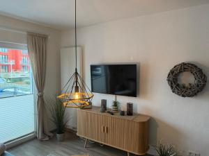 a living room with a flat screen tv on a wall at Apartment Alleestraße in Büsum