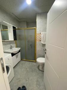 a bathroom with a toilet and a sink and a shower at Ada Mevan Otel in Ipekyolu +8 photos