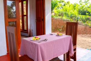 a table with a pink and white checkered table cloth at Cloud 9 Cottages Ella in Ella