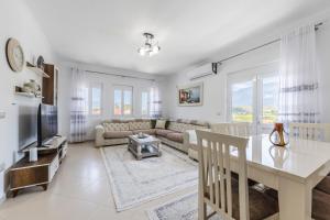 a living room with a couch and a table at Castle Serenity Home 3BR with Free Parking by PikHost in Gjirokastër