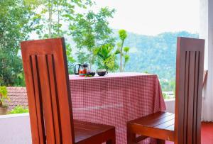 a table with a red and white checkered table cloth at Cloud 9 Cottages Ella in Ella