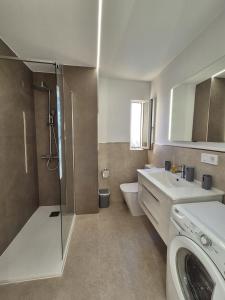 a bathroom with a shower and a toilet and a sink at Vibre Canaris - Las Americas in Playa de las Americas