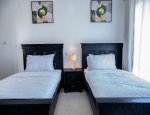 two beds sitting next to each other in a bedroom at Ngao #220 Swara Ranch in Nanyuki +27 photos