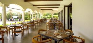 a row of tables and chairs in a restaurant at Ngao #220 Swara Ranch in Nanyuki