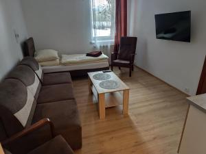 a living room with a couch and a table at Zajazd Kadar in Wisła +74 photos