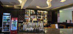 a bar with glasses on a counter in a room at The Africana Hotel in Isiolo